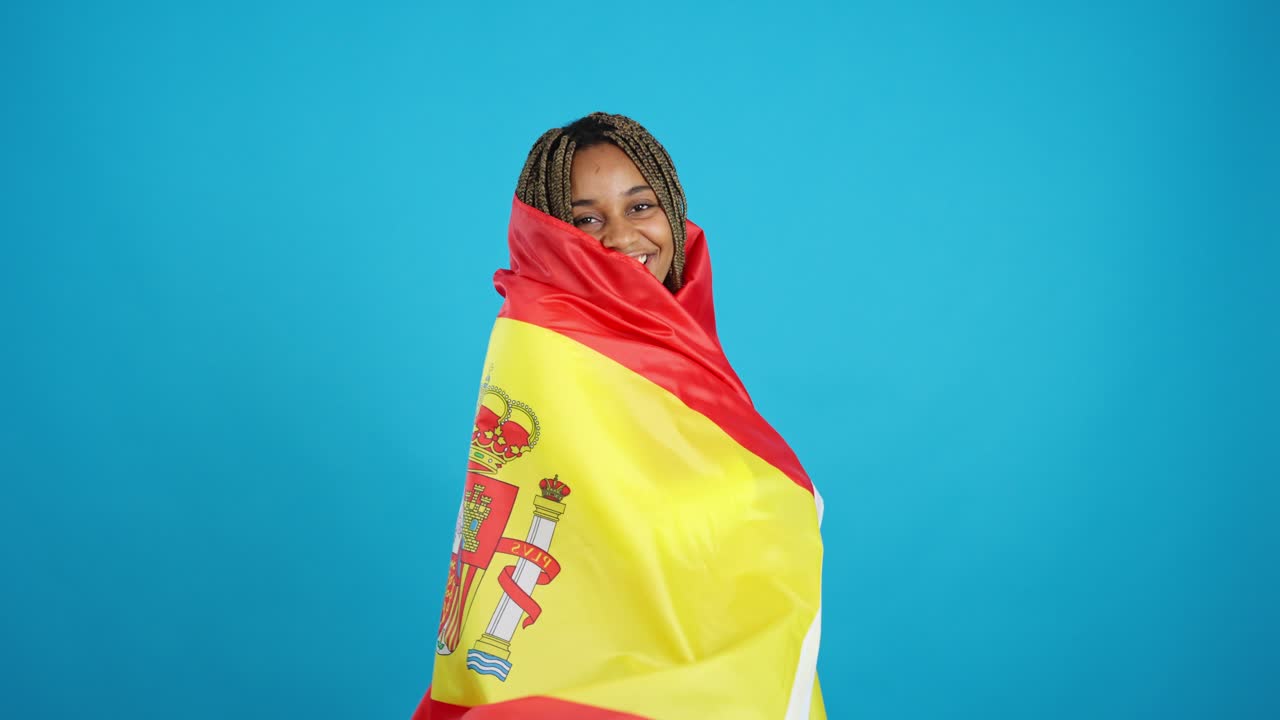 Happy woman proudly displaying the Spanish flag