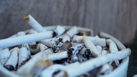 smoking cigarette in ashtray on table