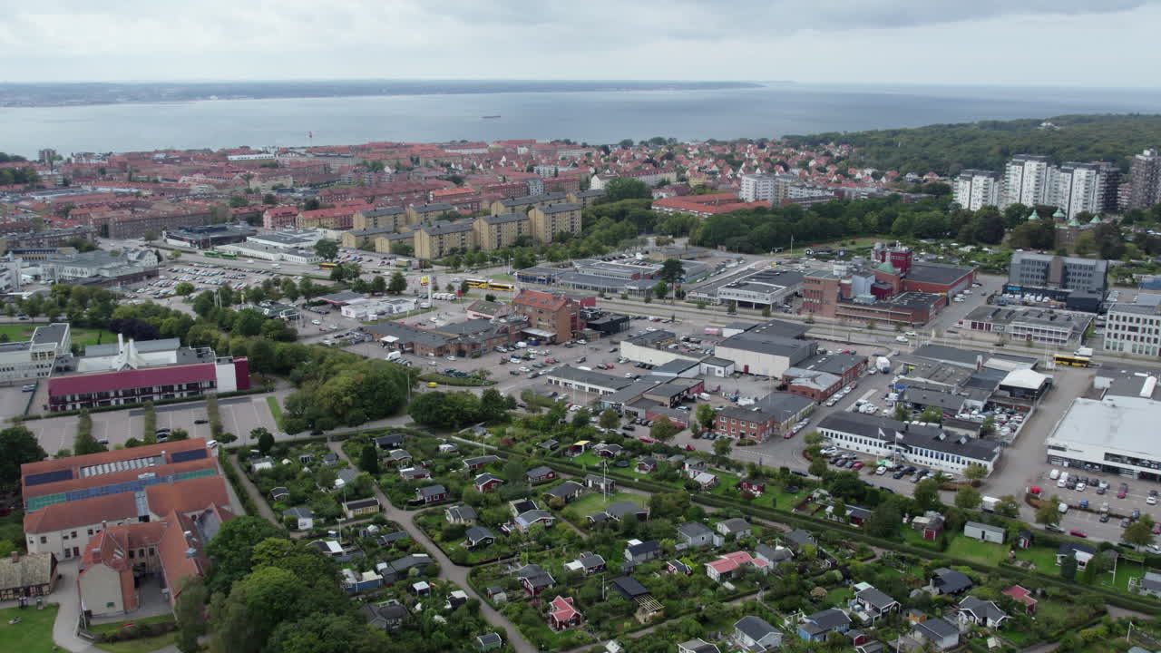 Fredriksdal Museum and Gardens, Helsingborg, Sweden - A Wide Look at the City’s Buildings and Surrounding Green Garden Areas, All Set Near the Calm Coastline under a Cloudy Sky - Aerial Drone Shot
