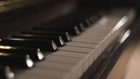 keyboard on vertical piano seen from the left side, close up, shallow focus