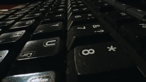 camera flyover over a black russian-english keyboard.