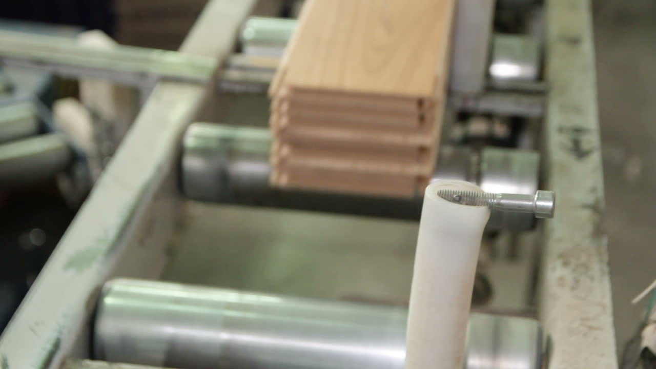 Parquet moving in a special device. Production line in woodworking factory