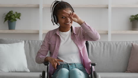 Young Woman in Wheelchair Listening to Music and Dancing
