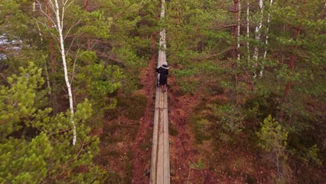 Frau-Trägt-Baby-Im-Kinderwagen-Im-Hölzernen-Naturpfadpark,-Luftaufnahmen