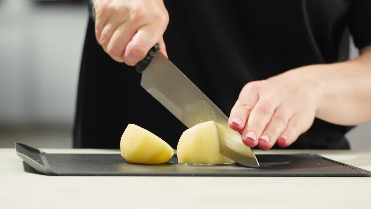 Cutting Potatoes on a Black Cutting Board