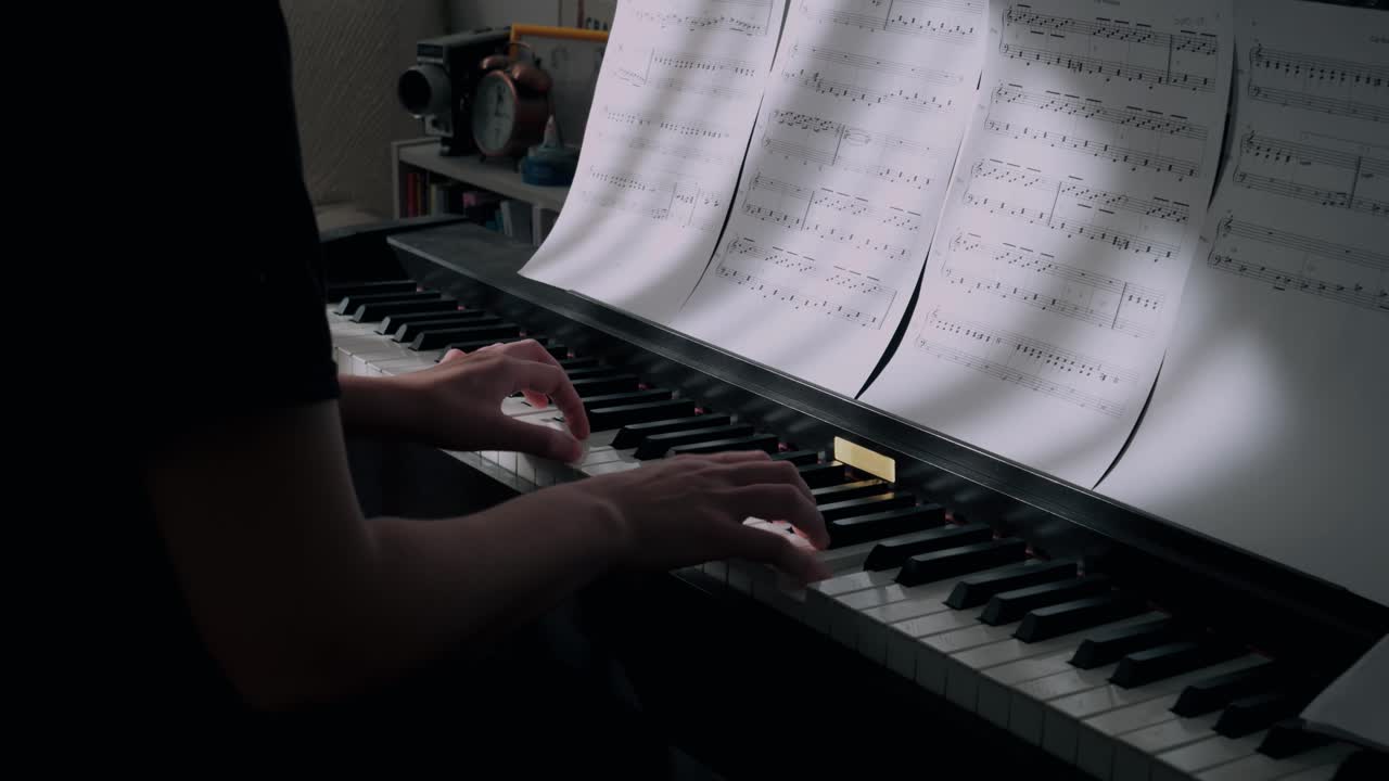Hands Playing Piano with Sheet Music on Keyboard