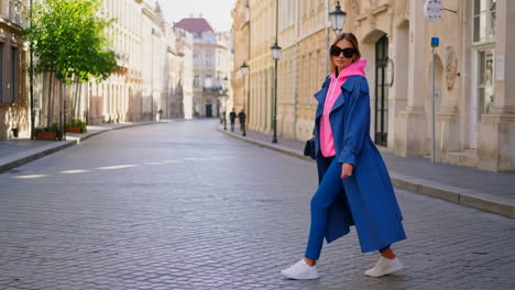 stylish woman walking on a cobblestone street