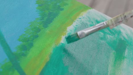 paint brush strokes on canvas with green acrylic paint