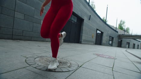 Closeup-female-legs-running-on-urban-street.-Fitness-woman-finishing-running