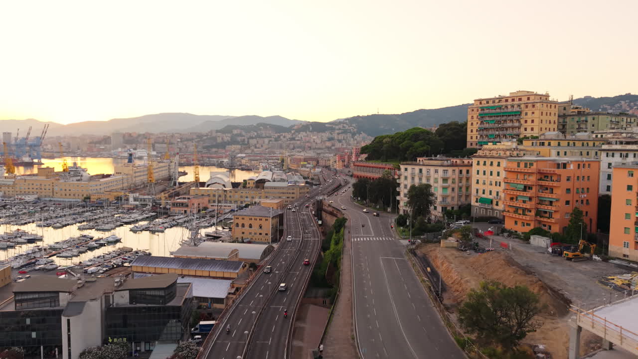 Aerial view of Genoa port, Italy, at sunset with bustling highways, city buildings and busy traffic, coastal view with urban landscape and marine industry
