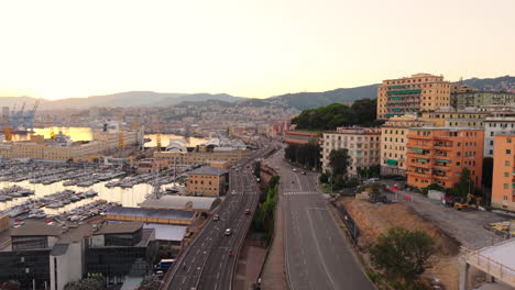 aerial view of genoa port, italy, at sunset with bustling highways, city buildings and busy traffic, coastal view with urban landscape and marine industry