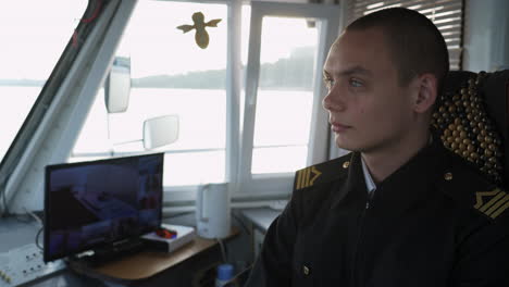 young officer on a ship's bridge