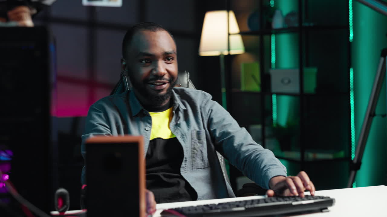 Joyous gamer competing in intense internet multiplayer videogame