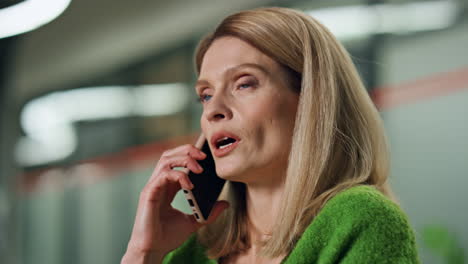 serious businesswoman talking cellphone indoors portrait. close up ceo calling