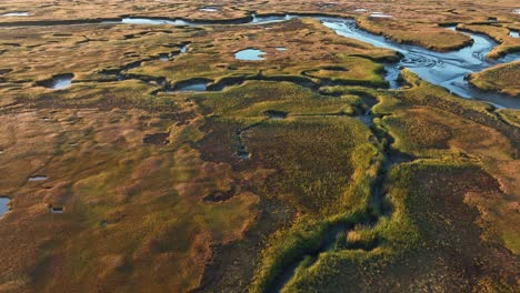 drone shot of patches on salt marsh during sunrise at cape cod, barnstable massachusetts in usa.