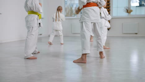 kids in white kimono in martial arts class