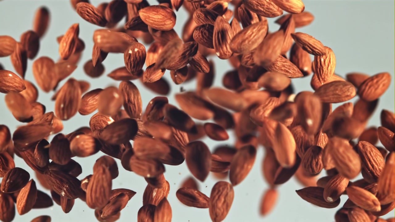 Many Almonds Falling and Floating in Slow Motion