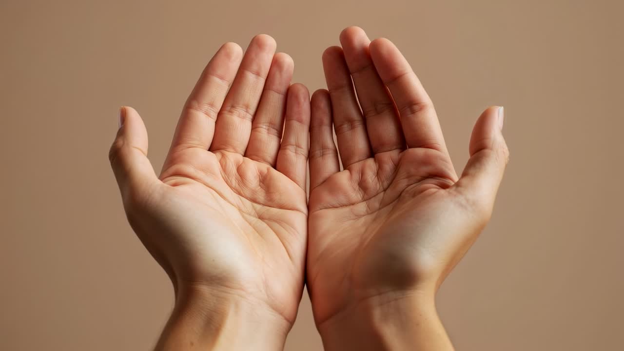 Starting with palms cupped, pair of hands making finger shifts on beige set to display palms