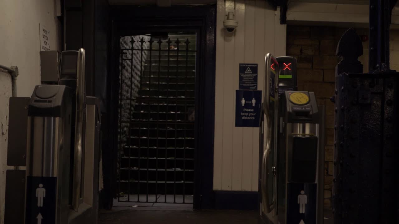 Lonely train station exit and ticket machines zoom out shot