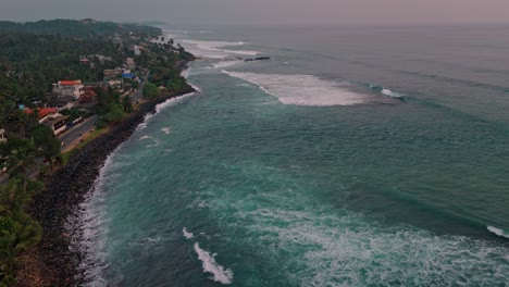 stunning aerial footage capturing the golden hues of sunset over the weligama coastline in sri lanka.