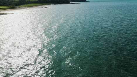 Aerial-still-view-of-glistening-waves-rippling,-slow-motion