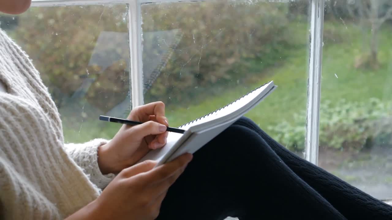 Woman sketching on notepad
