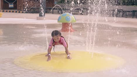 girl closes fountain jets by hands on resort slow motion