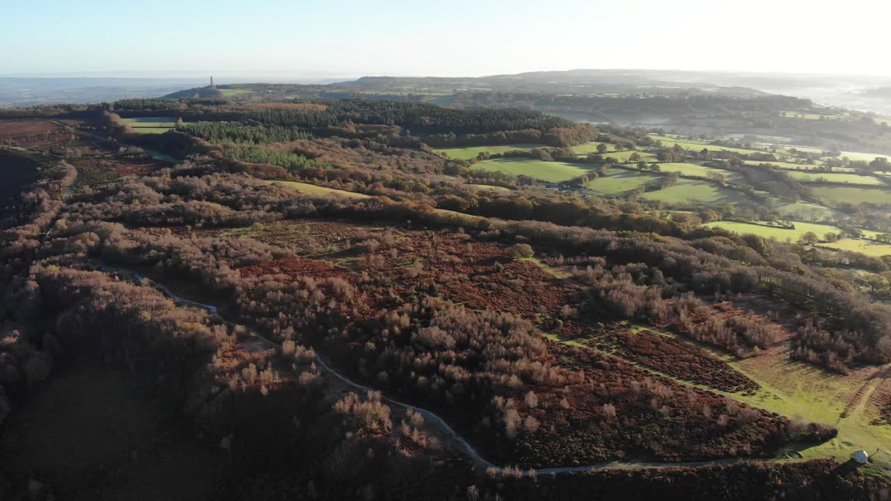 4K Aerial shot slowly descending above the vast rolling hills of Culmstock Beacon in the Blackdown Hills of Devon England