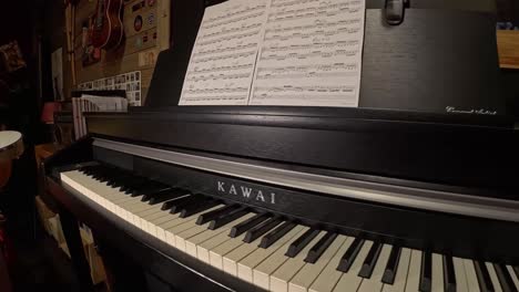 black piano with scores in elegant music studio, zoom out, no people