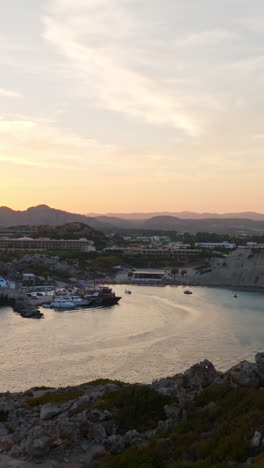 vertical drone shot of a greece flag at kolympia, sunny evening in rhodes