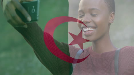 taking selfie, smiling woman with algerian flag animation in background