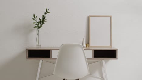 wooden frame with copy space on white background with plant on desk against white wall