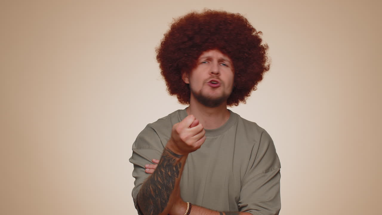 Aggressive angry man trying to fight at camera, shaking fist, boxing with expression, punishment