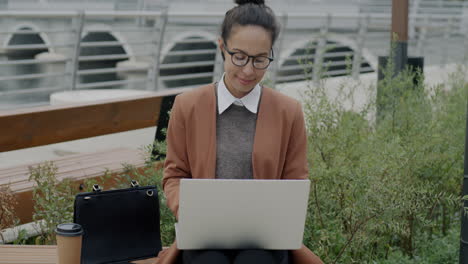 businesswoman working outdoors on laptop