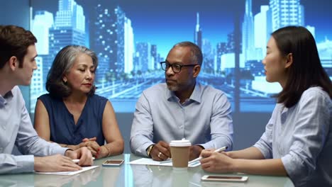 a diverse group of professionals engaged in a collaborative discussion during a meeting, analyzing strategies and ideas in a modern urban setting