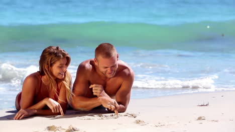 lovely couple lying on sand