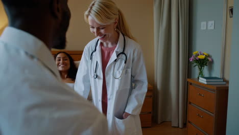 doctor visiting patient in hospital room