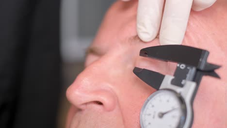measuring facial features with a caliper