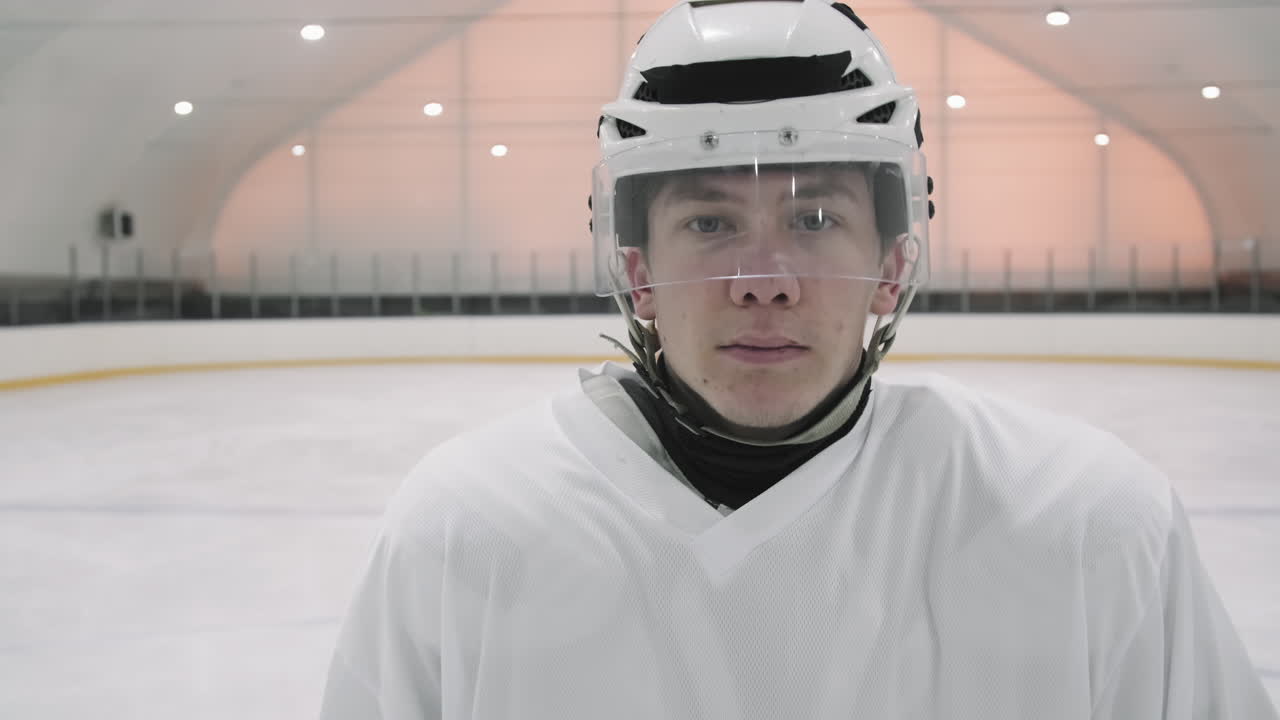 Portrait Of Brutal Hockey Player With Stick