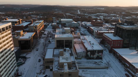 flyover winter urban landscape of fayetteville, arkansas at sunset