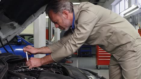 Mechanic-servicing-a-car-engine