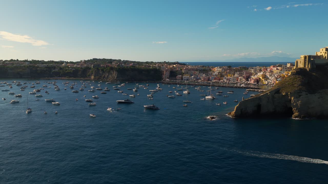 Colorful Fishing Village Of Marina Corricella On The Island Of Procida, Italy At Sunset. Aerial Rotating Shot