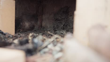 the man is applying cement to the interior of the stove located beneath the diy hot tub - close up