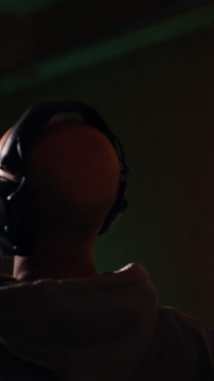 Vertical video People in shooting gallery training with handguns, sharpening skills