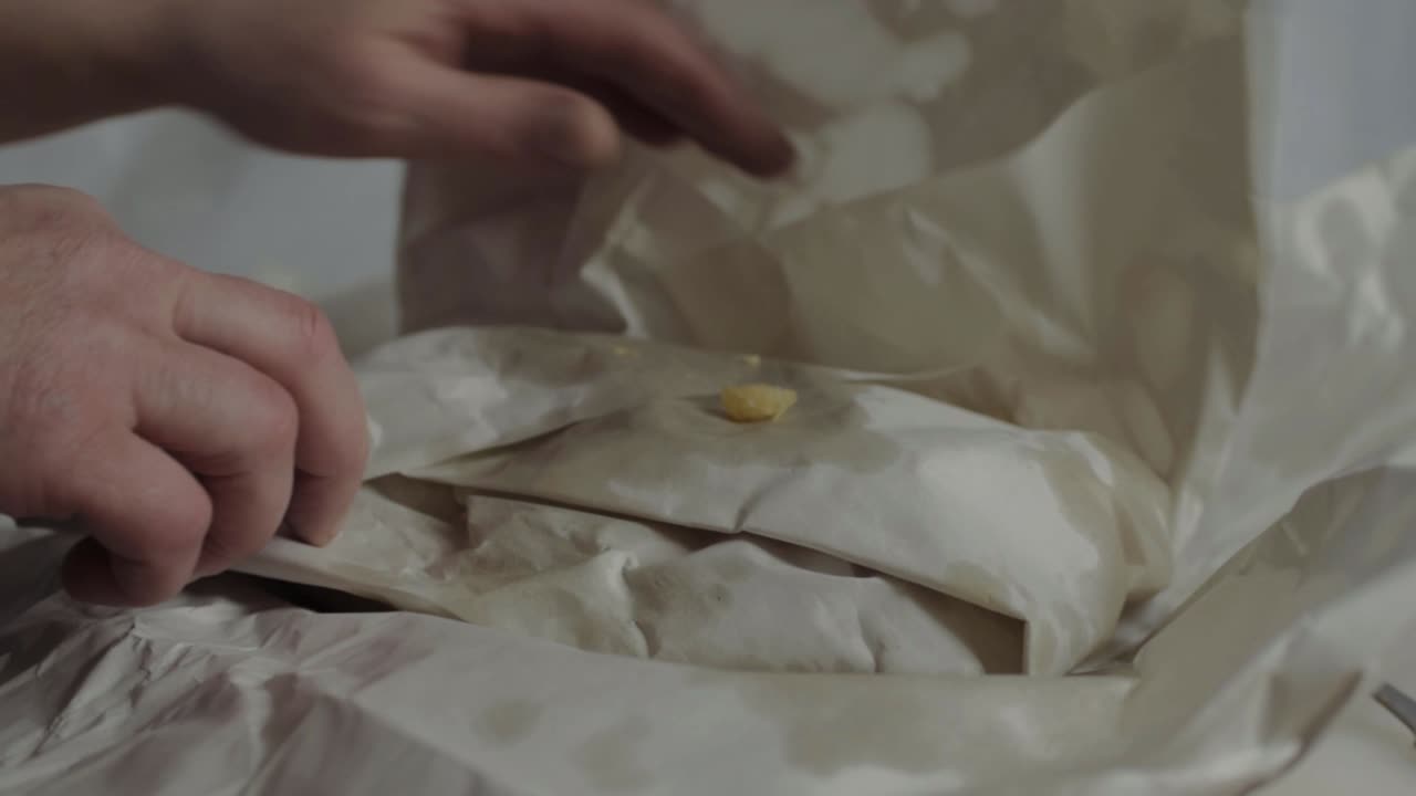 Hand unwrapping fish and chips side close up shot