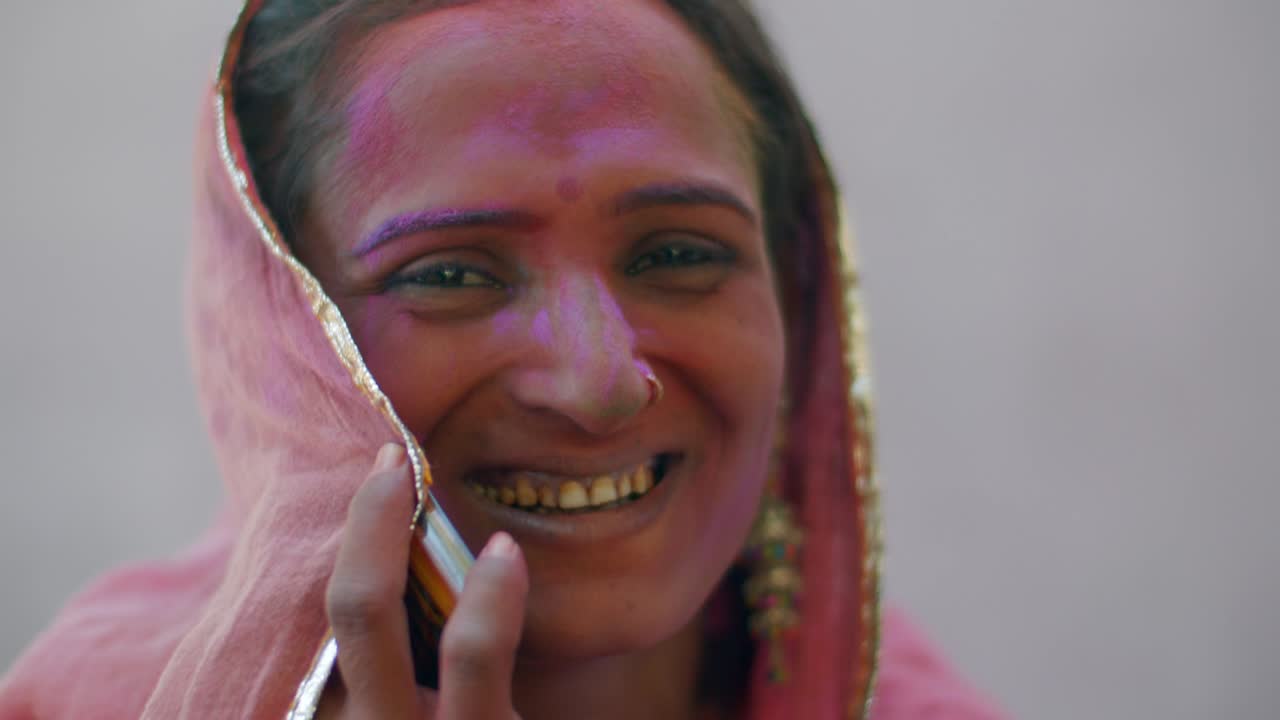 Indian women close-up of face smeared with bright Holi colors