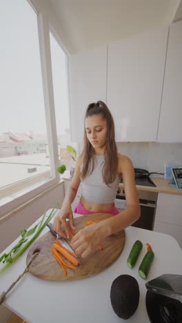 young woman peeling carrots in a bright kitchen