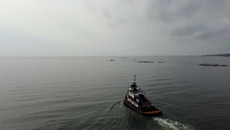 Aerial:-Tugboat-pulls-into-open-ocean