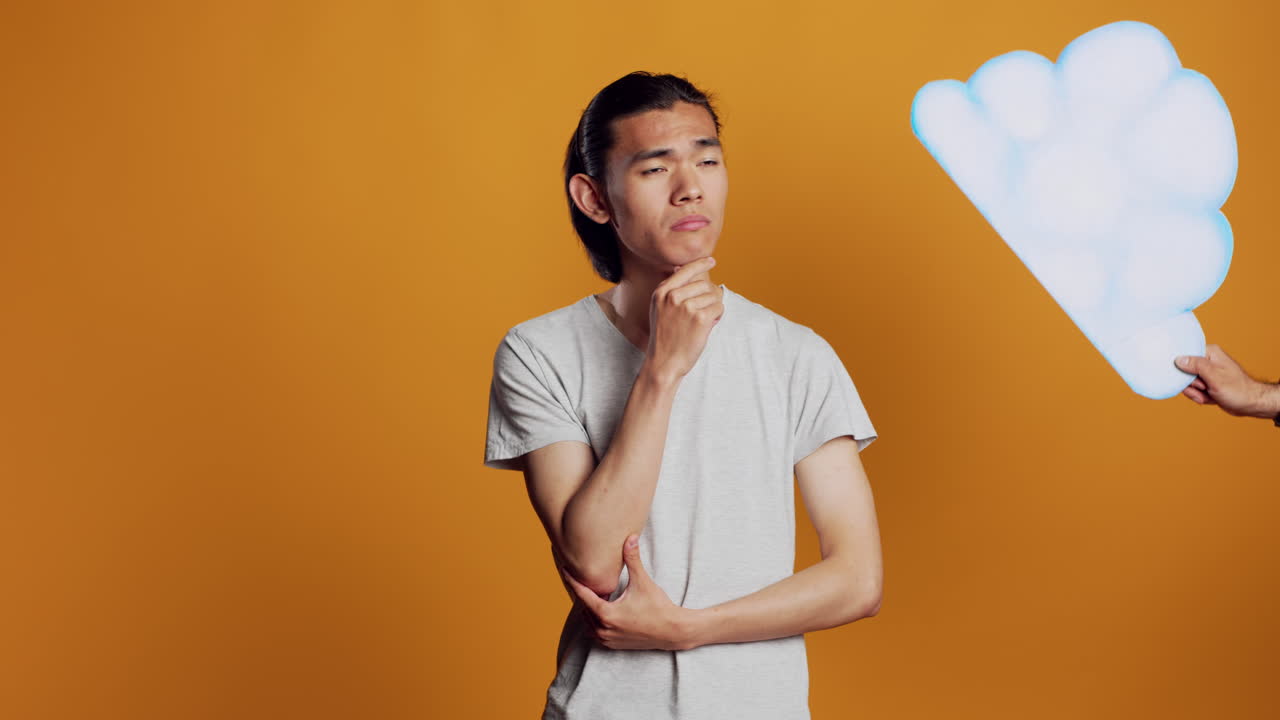 Thoughtful young man having bardboard cloud