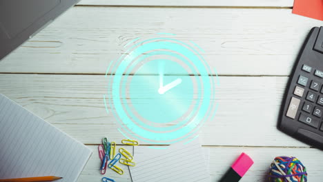 animation of clock moving over desk with notebook and calculator on desk